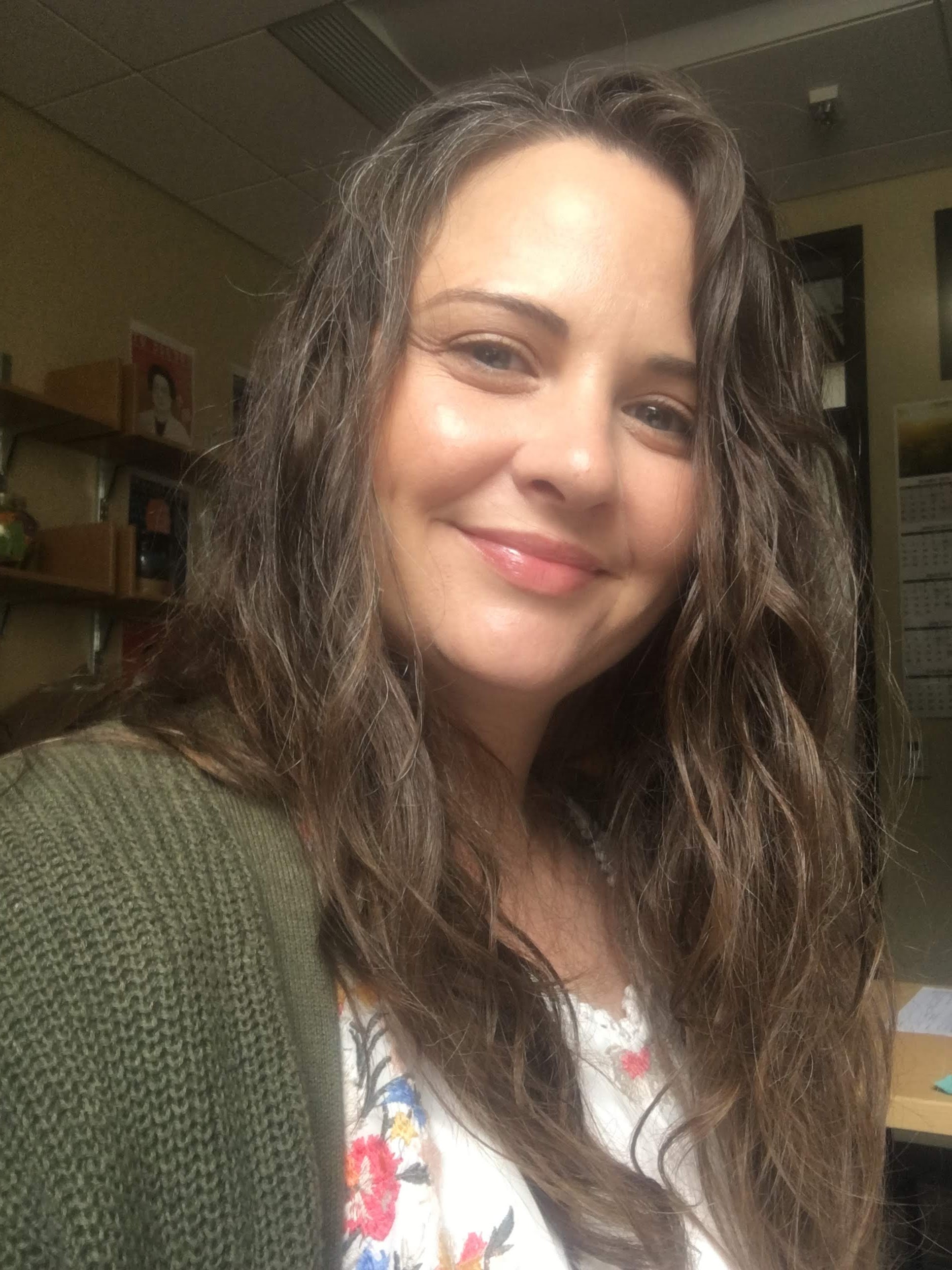 Rachel is smiling at the camera.