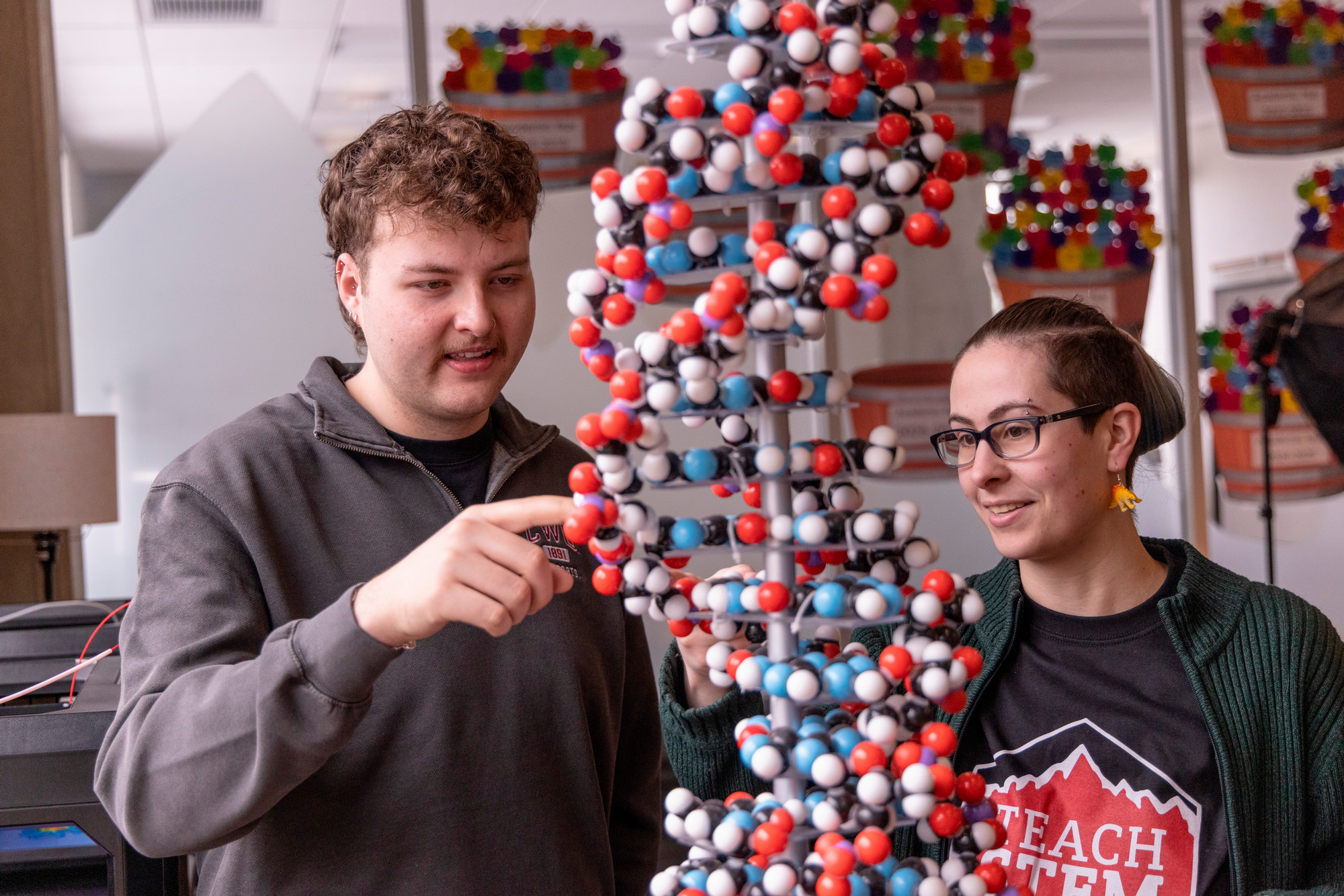 Two students looking at DNA model