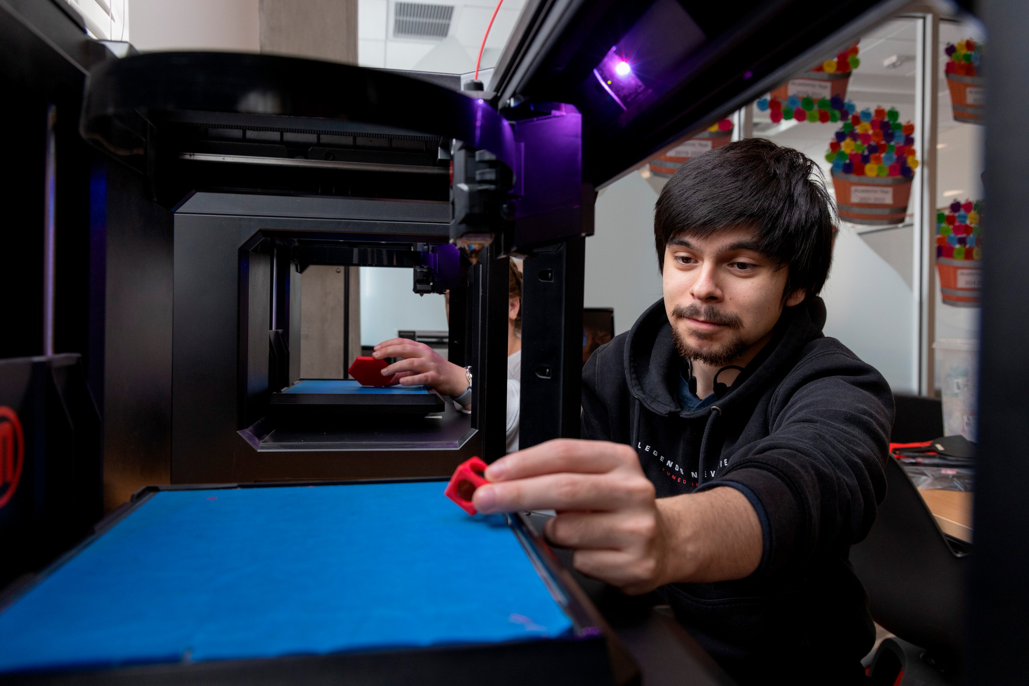 Student looking at 3D print