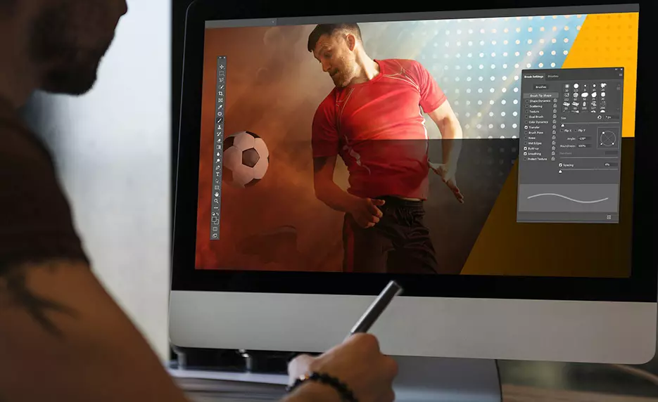 Person photoshopping images on a computer