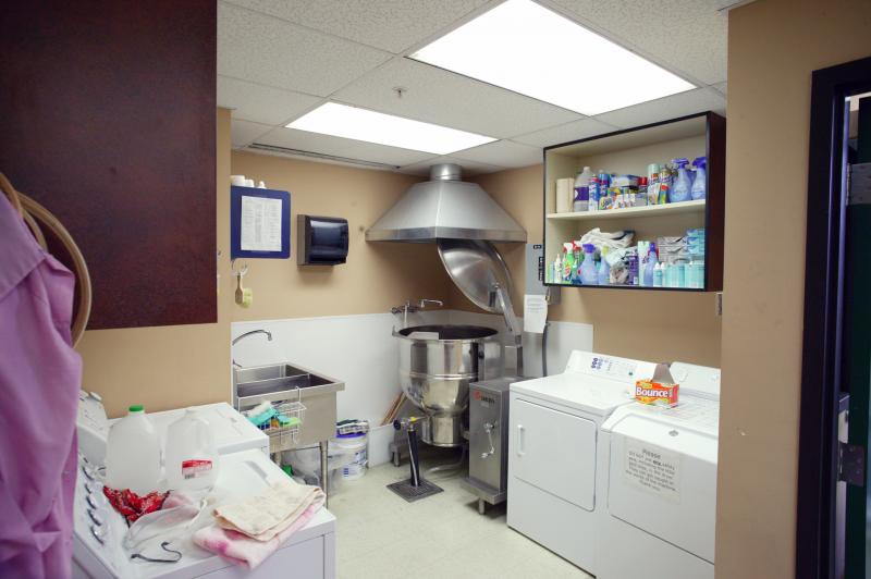 The costume and craft room. There are washing machines and driers in the room.