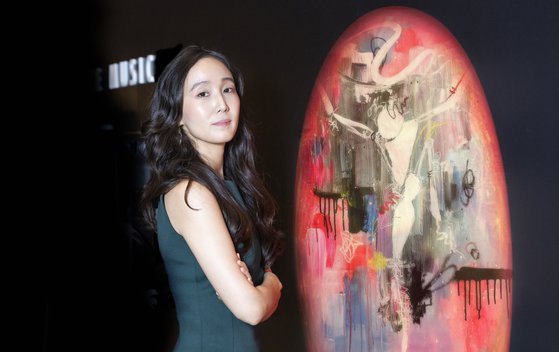 Dr. Chuyun posing for the photo. She is wearing a turquoise tank top.