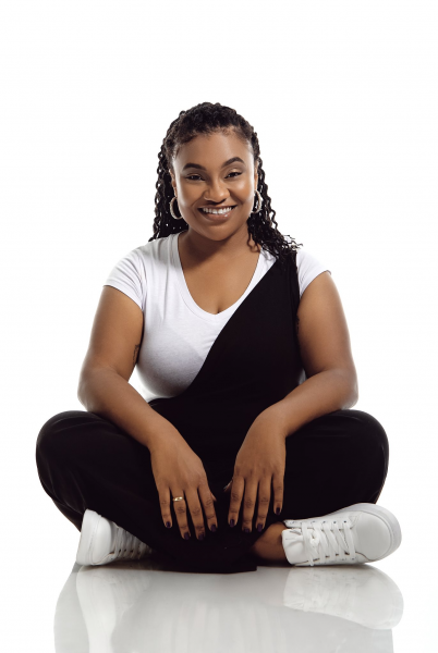 Frankie Lewis sitting crisscross smiling.