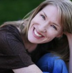 Headshot of Sara Coiley smiling, the background is green.
