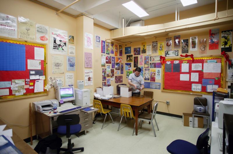 Theater's marketing lab. The wall is covered with posters from previous productions.