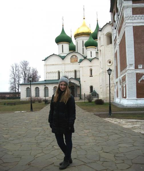 Student posing in front of a church in Moscow