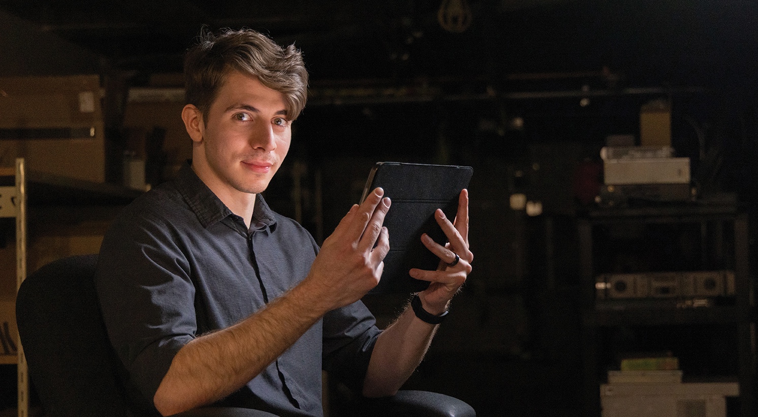 FlexIT graduate Kevin Lomax holding an Ipad meaningfully.