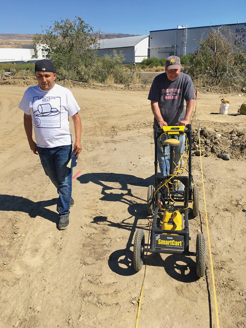 Shellenberger and a colleague use GPR equipment in the field