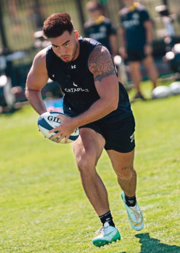 Alex Mackenzie doing a practice exercise. Other players can be seen in the background.