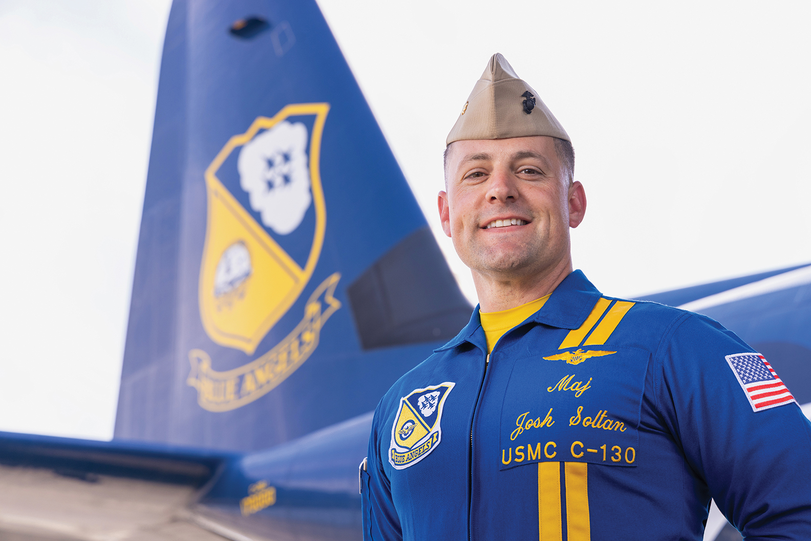 Josh Soltan stands in front of a Blue Angels plane