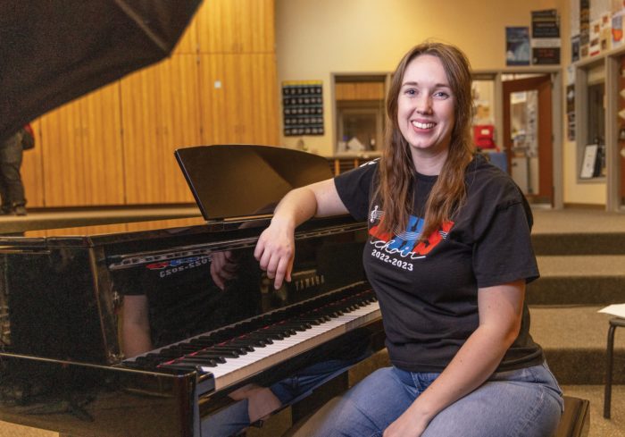 Brittany Stevens leaning against a black piano