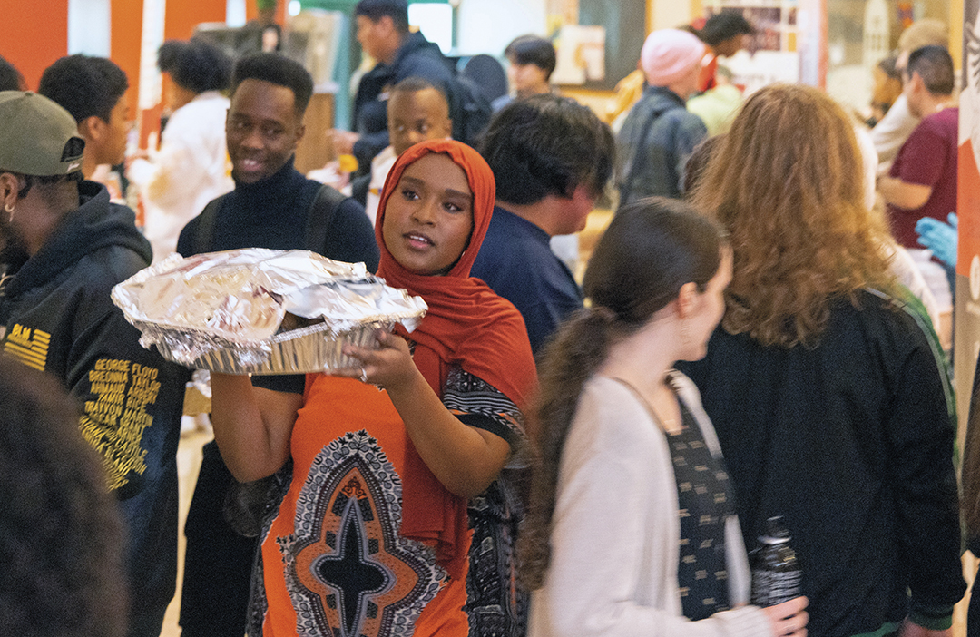 A Muslim student carries a tray of food inside the SURC