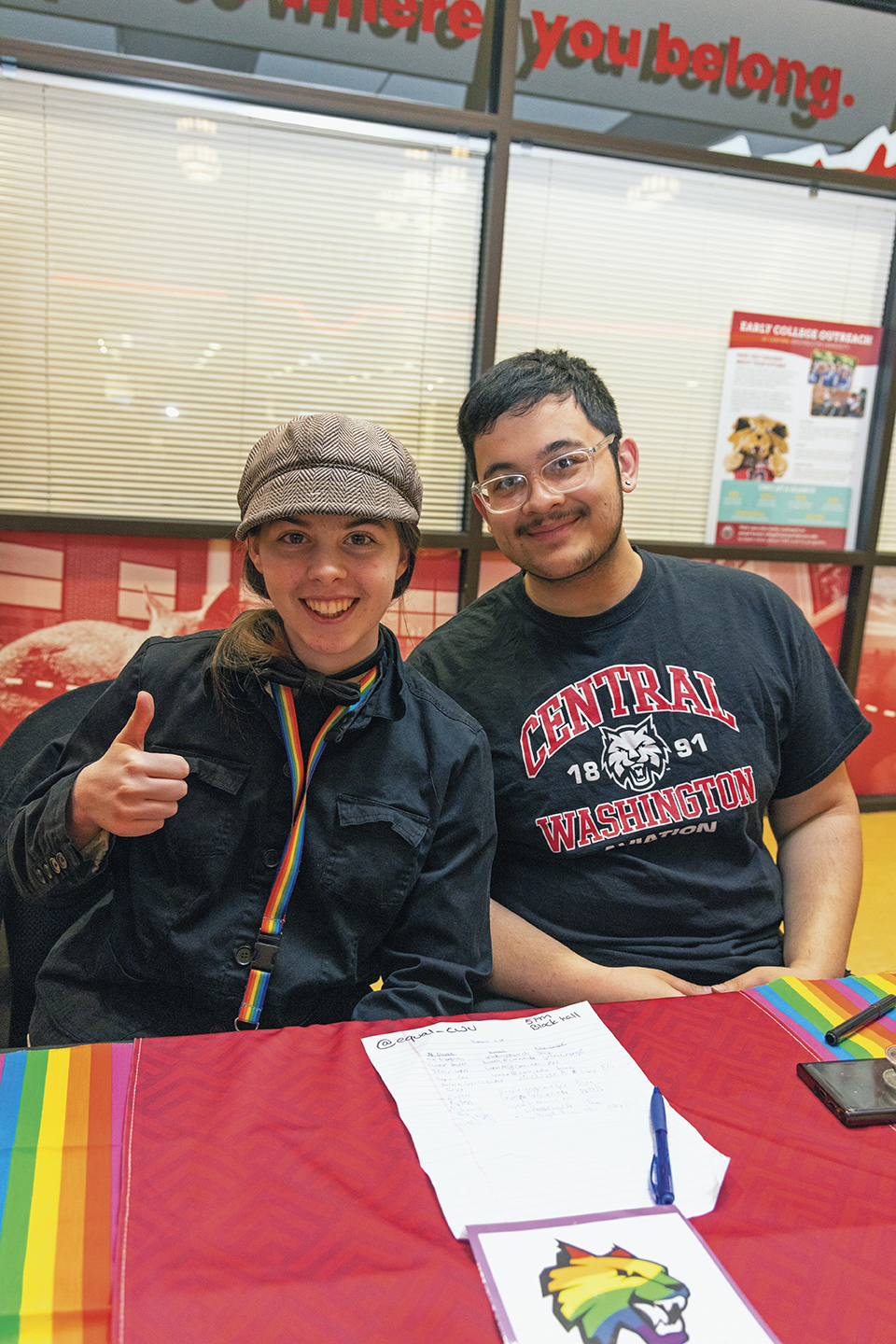 Two students promote a student club in the SURC