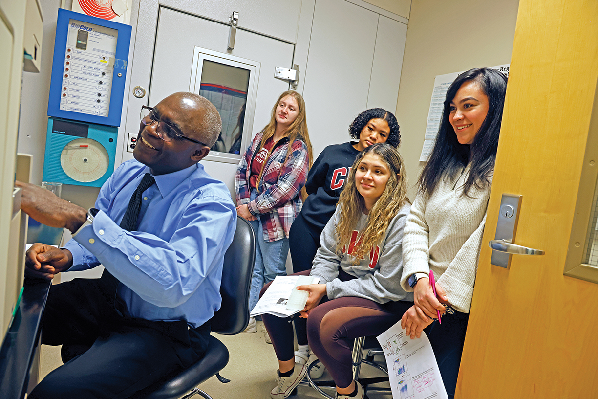 Biology professor Blaise Dondji works with students in a lab