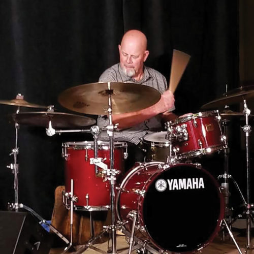 Gary Hobbs playing the drums on a red Yamaha drumset 