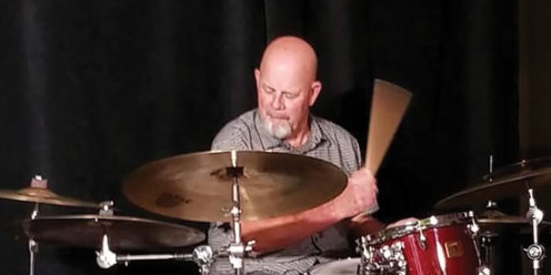Gary Hobbs plays the drums