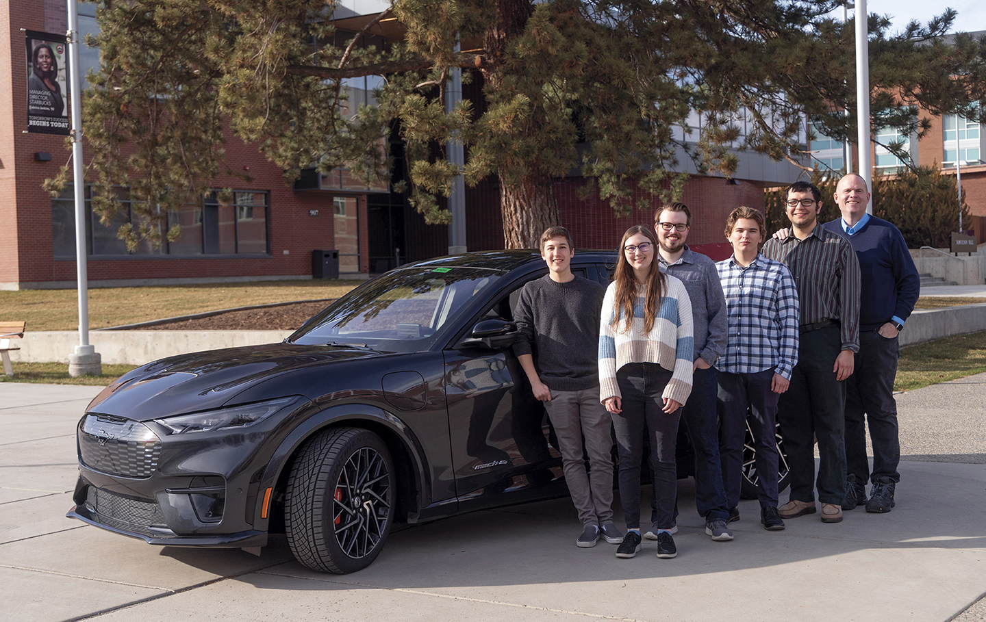 Photo of the student team with a Ford car, alongside team sponsor Bob Rapp