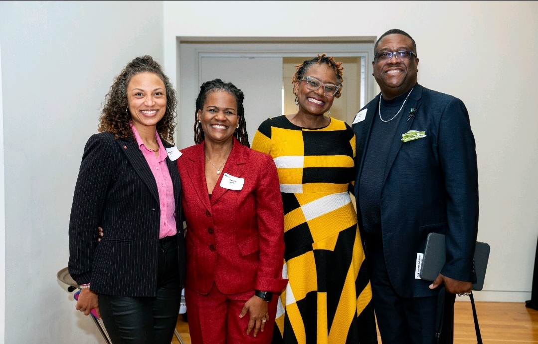 CWU alumna Lachandra Baker with a group of clients