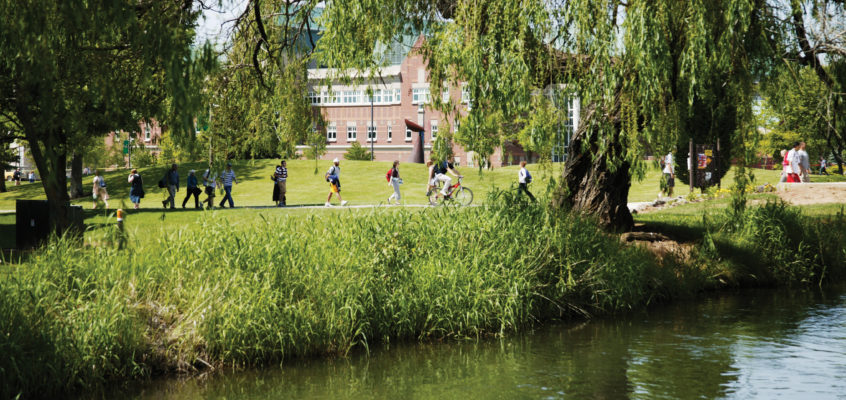 Students walking through campus seen at a distance.