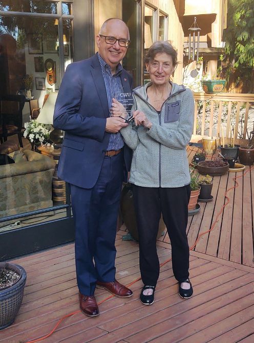 Madalon Lalley standing next to another person while holding a distinguished award between them.