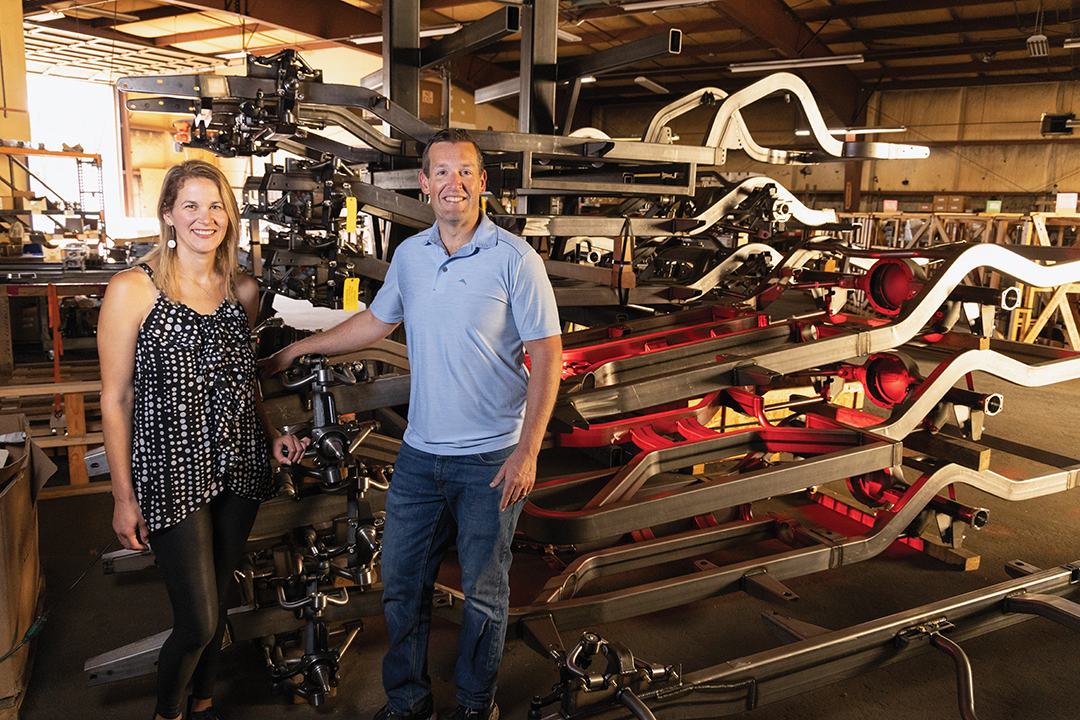 Matt and Lisa Jones stand inside their auto repair shop
