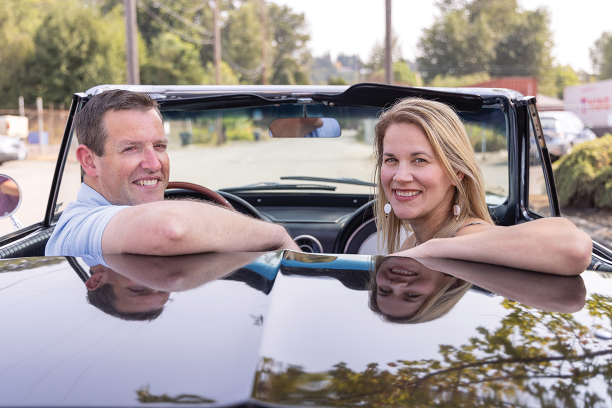Matt and Lisa Jones sit in a classic car