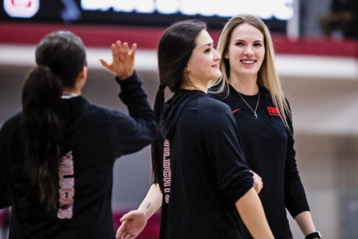 Sam Bowman and two other players wearing black CWU clothing on the basketball court.