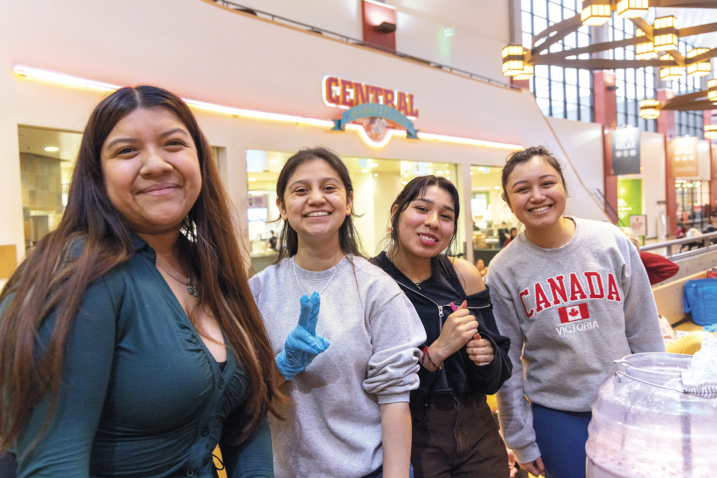 Four students smiling inside the SURC