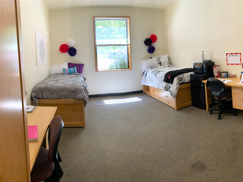 View of room showing two beds, two desks, two chairs, and the microwave fridge combo