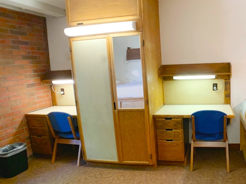Two desks with a closet between them