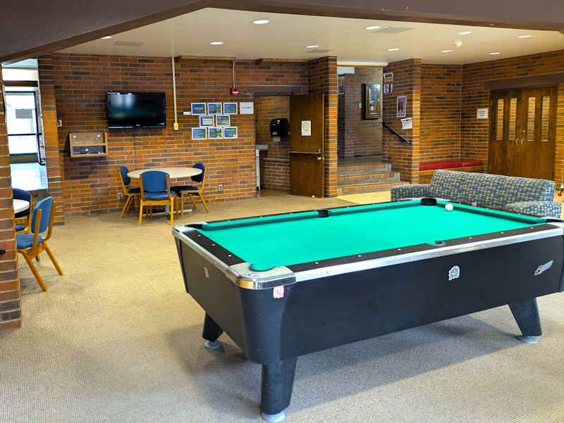 Lounge with pool table, couches, and chairs