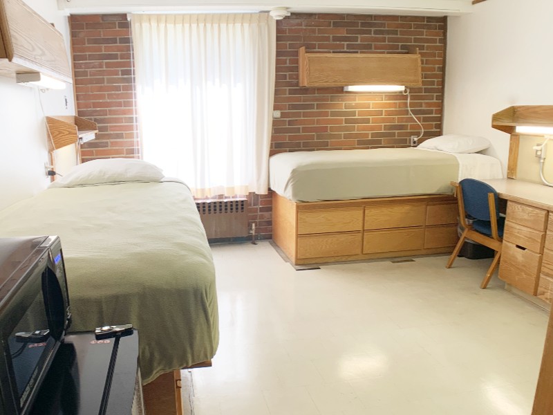 Two beds, two desks, and a window