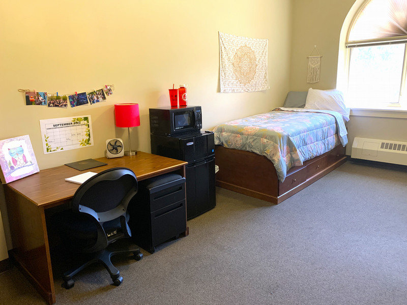 Room with twin XL bed, desk, and closet