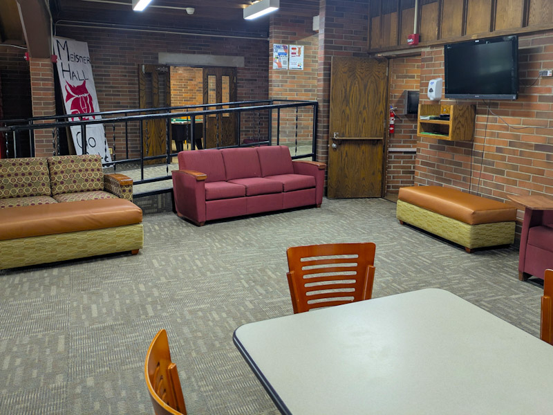 Lounge with couches, tables, and chairs