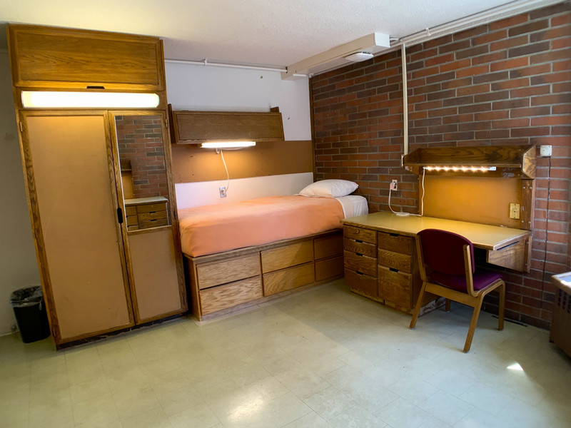 Room with twin XL bed, desk, and closet