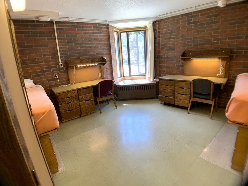 Corner room with bay window between two desks