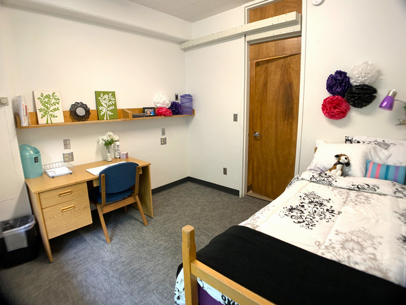 Bedroom with twin XL bed, desk, and desk chair