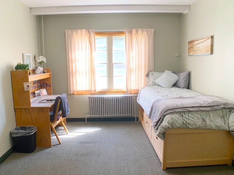 Room with twin XL bed, desk, and closet