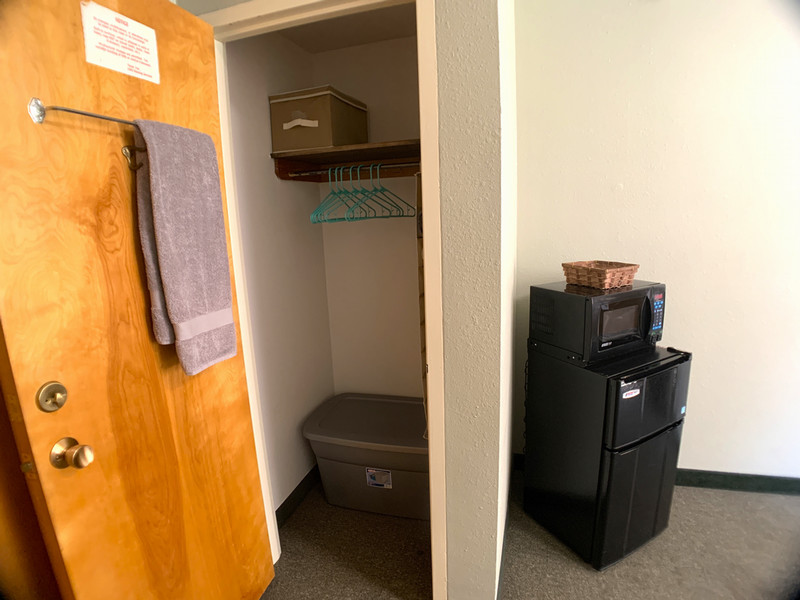 Close up of inside of closet with hanging rod and shelf at top