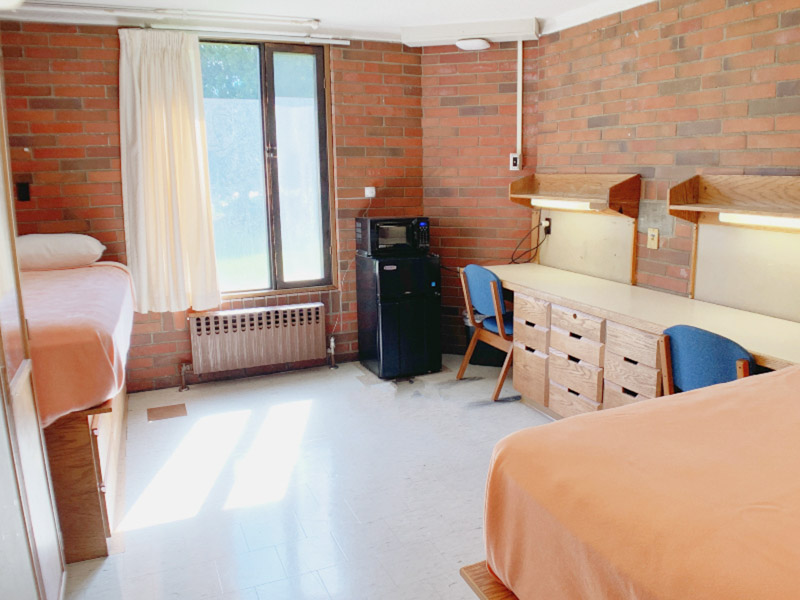 Room with twin XL bed, desk, and closet