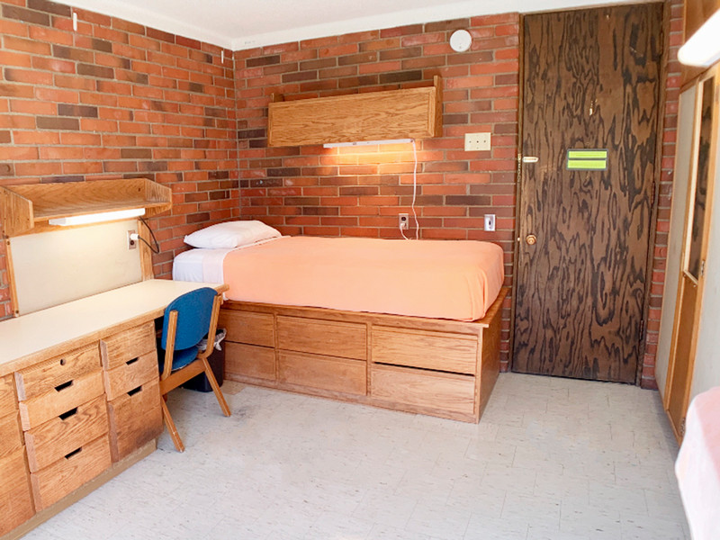 Twin XL bed, room entrance door, and a closet