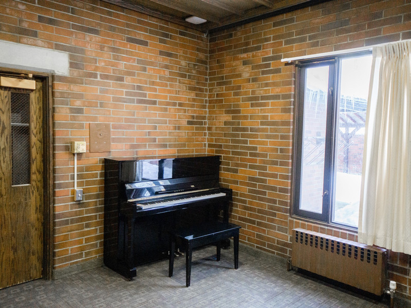 Piano room with piano, table, and chairs