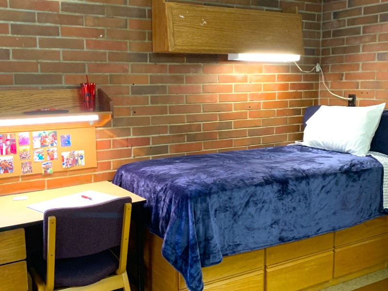 Room with twin XL bed, desk, and closet