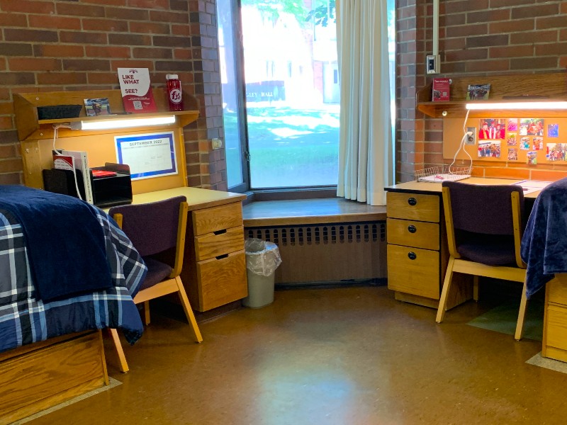 Corner room with bay window between two desks