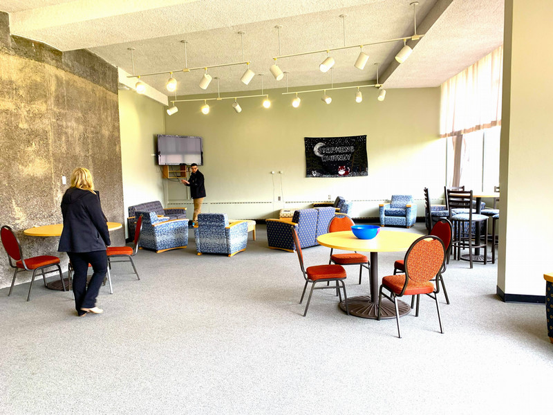Lounge with couches, chairs, and a TV