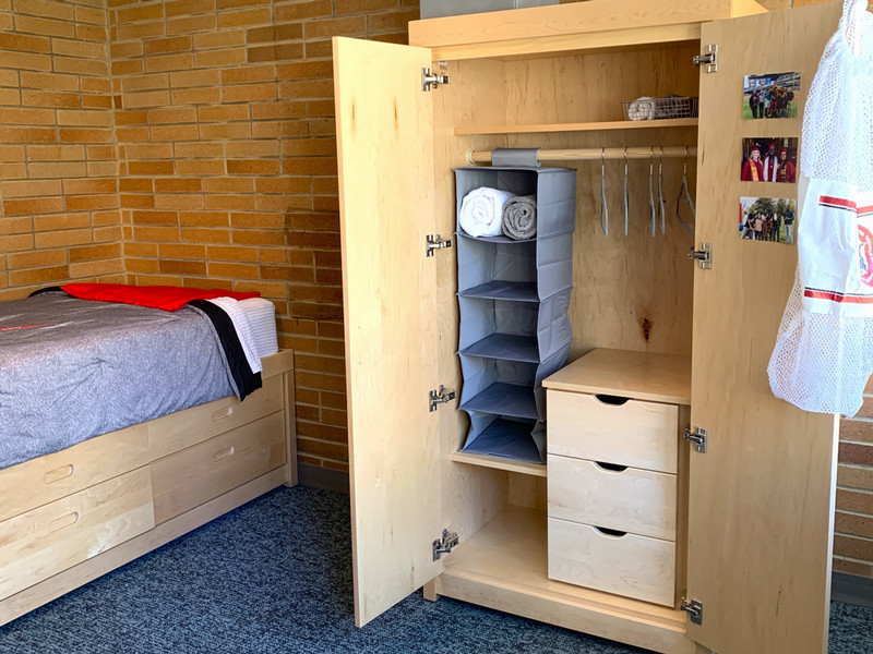 Closet with hanging bar, drawers, and shelf