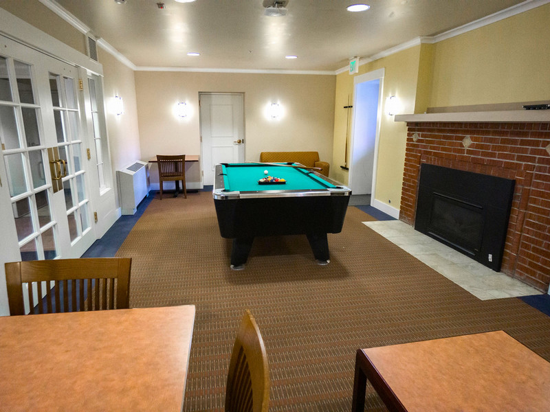 Pool table in room with fireplace