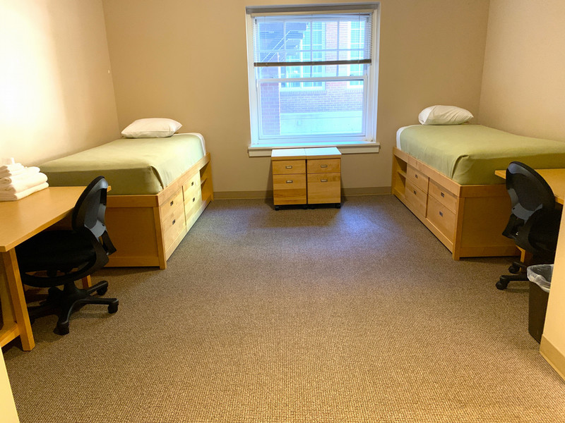 Room with twin XL bed, desk, and closet