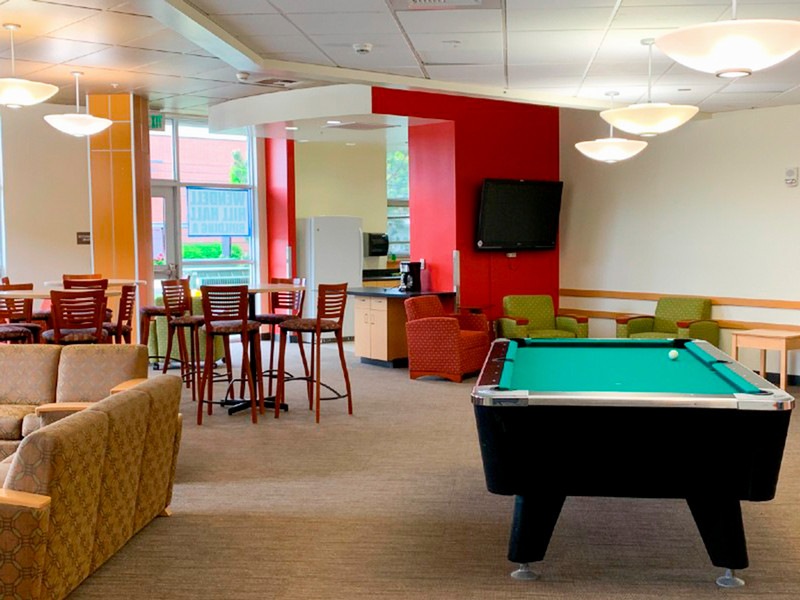 Lounge with pool table, TV, and tables and chairs