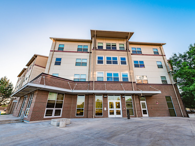 Outside of a four-story modern residence hall